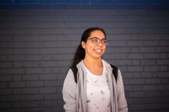 A student smiling outdoors on Kensington Campus