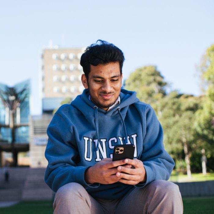 Student looking at their phone on campus