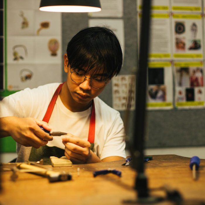 Student working at a bench in the Jewellery Studio on Paddington Campus