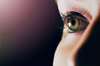 Studio shot of a man opening his eyes against a dark background