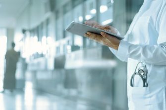 Healthcare and medicine. Medical and technology. Doctor working on digital tablet on hospital background