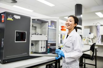 A laboratory technician working with engineering equipment