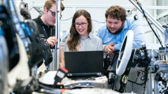 Engineering students behind laptop