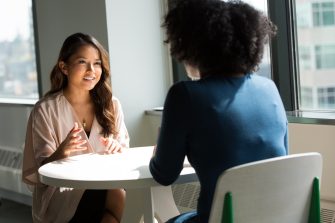 two women speaking to each other