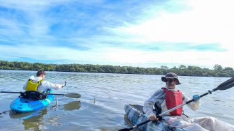 Jonathon Mayorga (left) and Michael Manefield (right) discharge bacteria-loaded cartridges into polluted Homebush Bay sediment.