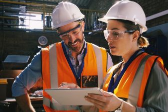 Two engineers looking at checklist