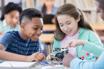 primary school stundents working with a robot