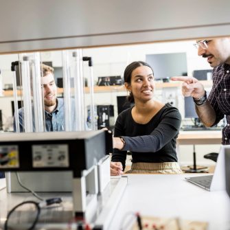 Engineering students in classroom with equipment