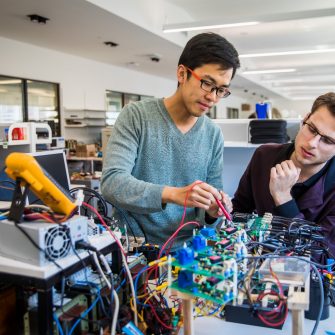 2 people using electrical engineering equipment