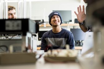 Students work with a lecturer to understand sophisticated practical telecommunications equipment