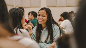 Two women in conversation in a cafeteria 