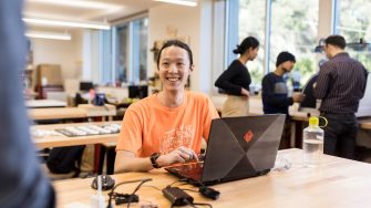 Student sitting at desk in Makerspace workshop
