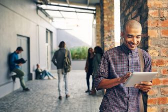 Student on campus looking at a tablet