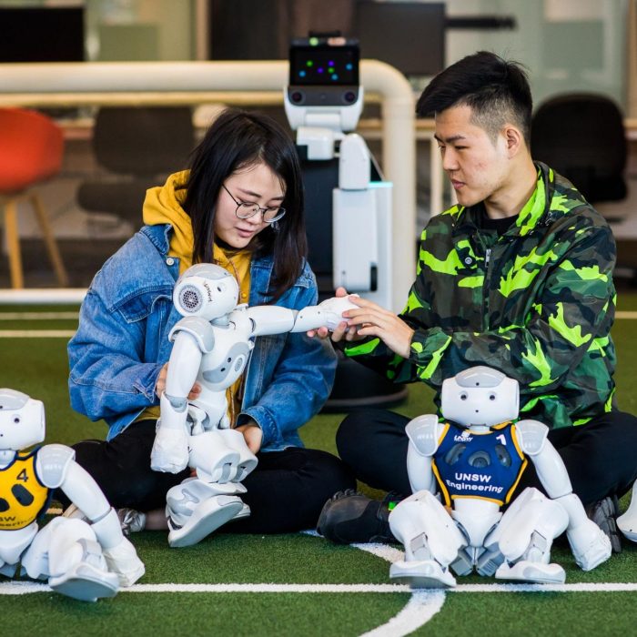 Engineering students working on robots