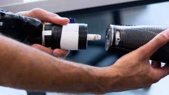 student holding prosthetic arm