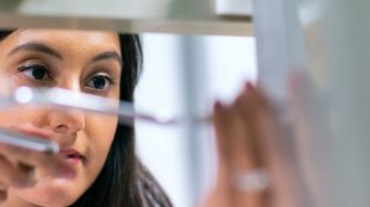 woman in lab holding object