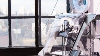 3d printer and laptop on white table