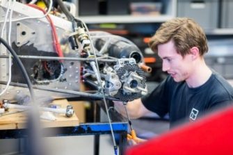 Mechanical engineer looking at engine