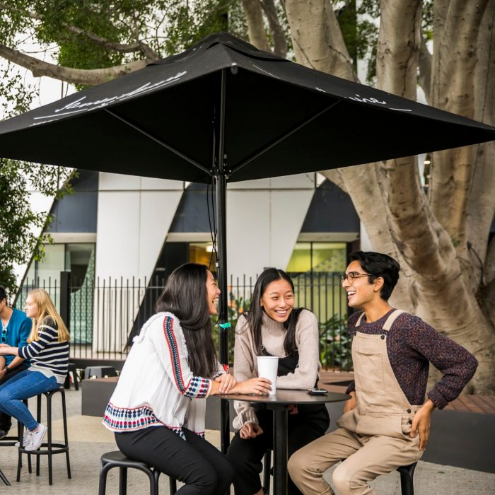Groups of students are happily chatting at outside tables in the Roundhouse beer garden