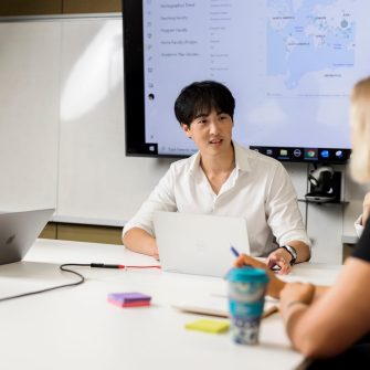 A group of people in conversation in a corporate setting. 