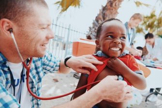 Shot of a volunteer doctor giving checkups to underprivileged kids
