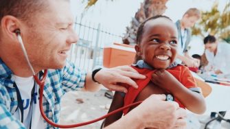Shot of a volunteer doctor giving checkups to underprivileged kids