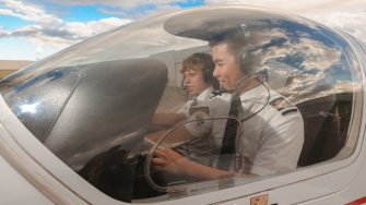 Two Male Students Flying Plane