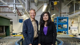 Two people standing in a factory