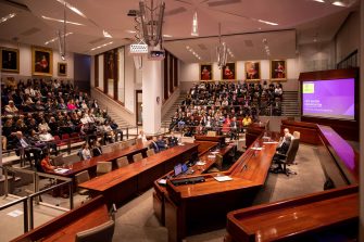Wide shot of the audience and speakers at the Mason Conversation event in 2019