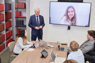 Students in Law PhD Room talking to other students with remote access via internet.