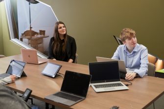 Students in Law PhD Room talking to other students with remote access via internet.