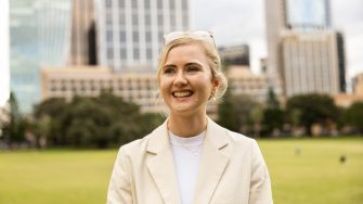 Smiling Law student standing in a park in Sydney CBD