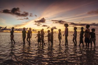 Children play in the sunset on one of the atolls at the Carteret islands. IOM conducted an assessment of the communities in Carteret Islands to know how their lives are being affected by climate change and how well they are adapting to the changing landscape. Photos: IOM / Muse Mohammed 2016