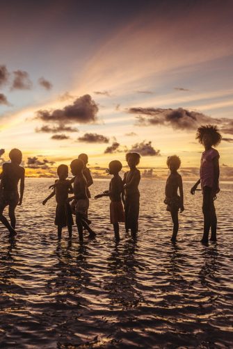 Children play in the sunset on one of the atolls at the Carteret islands. IOM conducted an assessment of the communities in Carteret Islands to know how their lives are being affected by climate change and how well they are adapting to the changing landscape. Photos: IOM / Muse Mohammed 2016