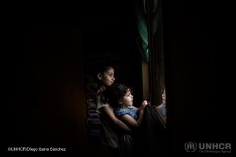 Ten-year-old Syrian refugee Layan plays with her three-year-old sister Yasmine Al Sham at their home in Barja, Lebanon. ; Wafaa Ahmad Hachem, 32, her husband Mouhamad Al Dali Al Masri, 37, their son Bakr, 13, and daughters, Layan, 10, Ghofran, 8, and Yasmine Al Sham, 3, come from the village of Gdaidet al Turkman in east Ghouta, just outside the Syrian capital Damascus. They fled to Lebanon in 2014, and are awaiting resettlement to Norway. The COVID-19 pandemic has suspended international resettlement for refugees worldwide, dividing some families and stranding them thousands of miles apart. UNHCR is concerned that international travel could increase the exposure of refugees to the virus. As resettlement remains a life-saving tool for many refugees, UNHCR is appealing to States to ensure that movements can continue for the most critical emergency cases wherever possible.
