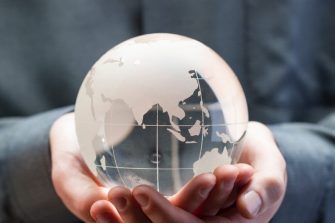holding a glass globe in hands