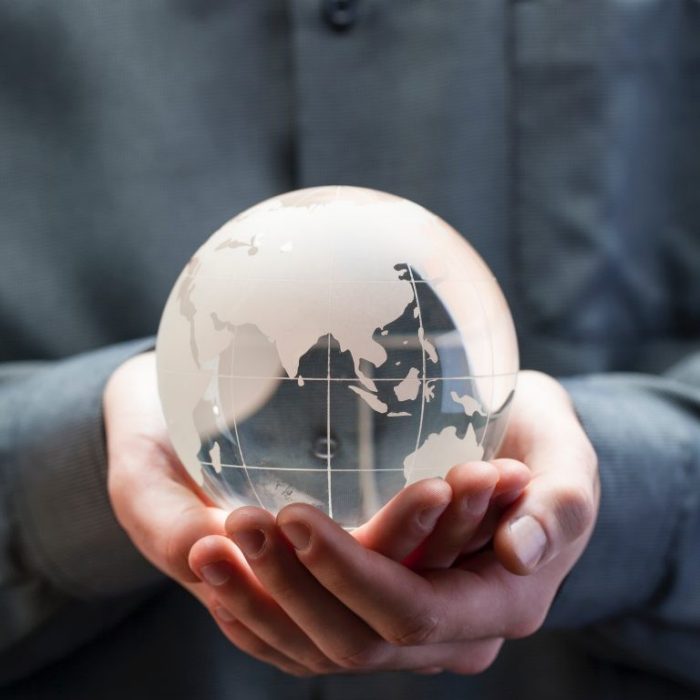 holding a glass globe in hands