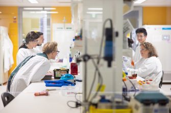 Scientists working at lab bench