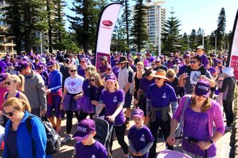 crowd walking with purple shirts