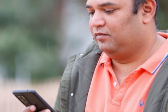 Person using smartphone to research mental health topics