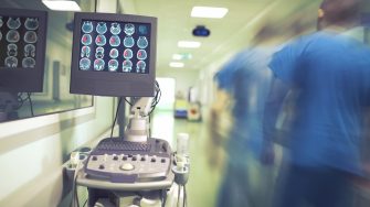 Male doctor hurrying in the hospital hallway to the emergency patient.