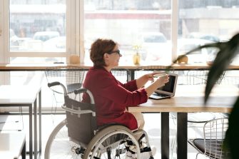 Woman in wheelchair at laptop