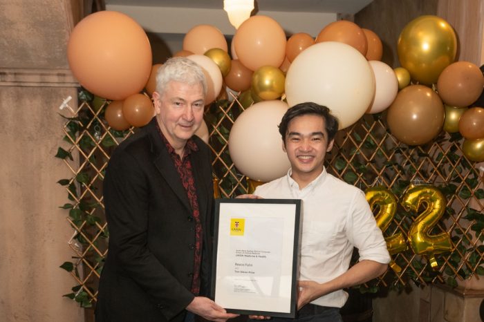 Student smiling and receiving an award