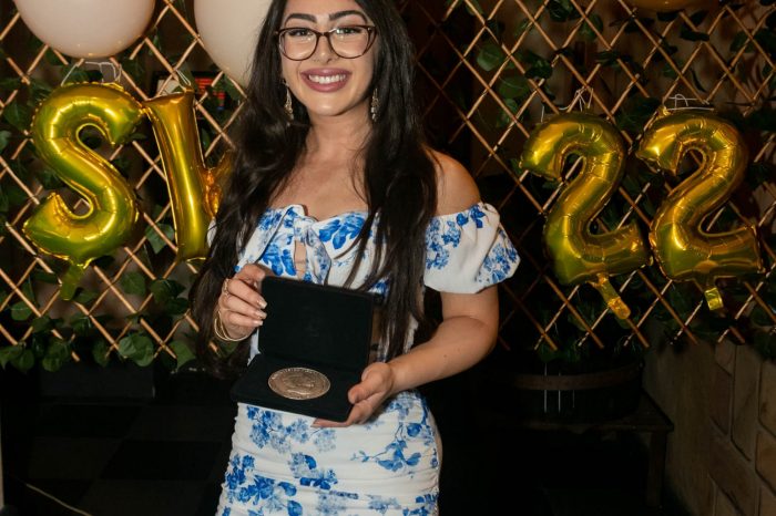 SWS Clinical Medicine Graduate posing for a photo with her medal