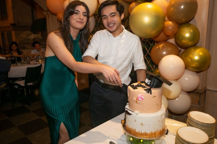 Two SWS Clinical Medicine Students cutting the cake 