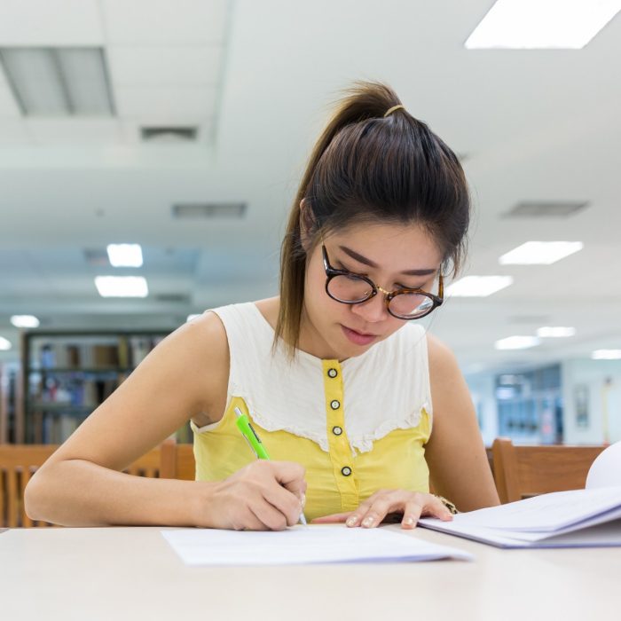 study education, woman writing on a paper, working women