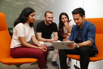 Students gathered around a tablet