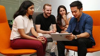 Students gathered around a tablet