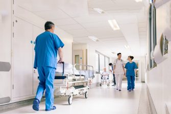 Doctors Hospital Corridor Nurse Pushing Gurney Stretcher Bed