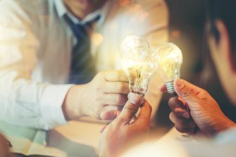 Sharing idea for help concept, Colleagues sharing a light bulb of idea